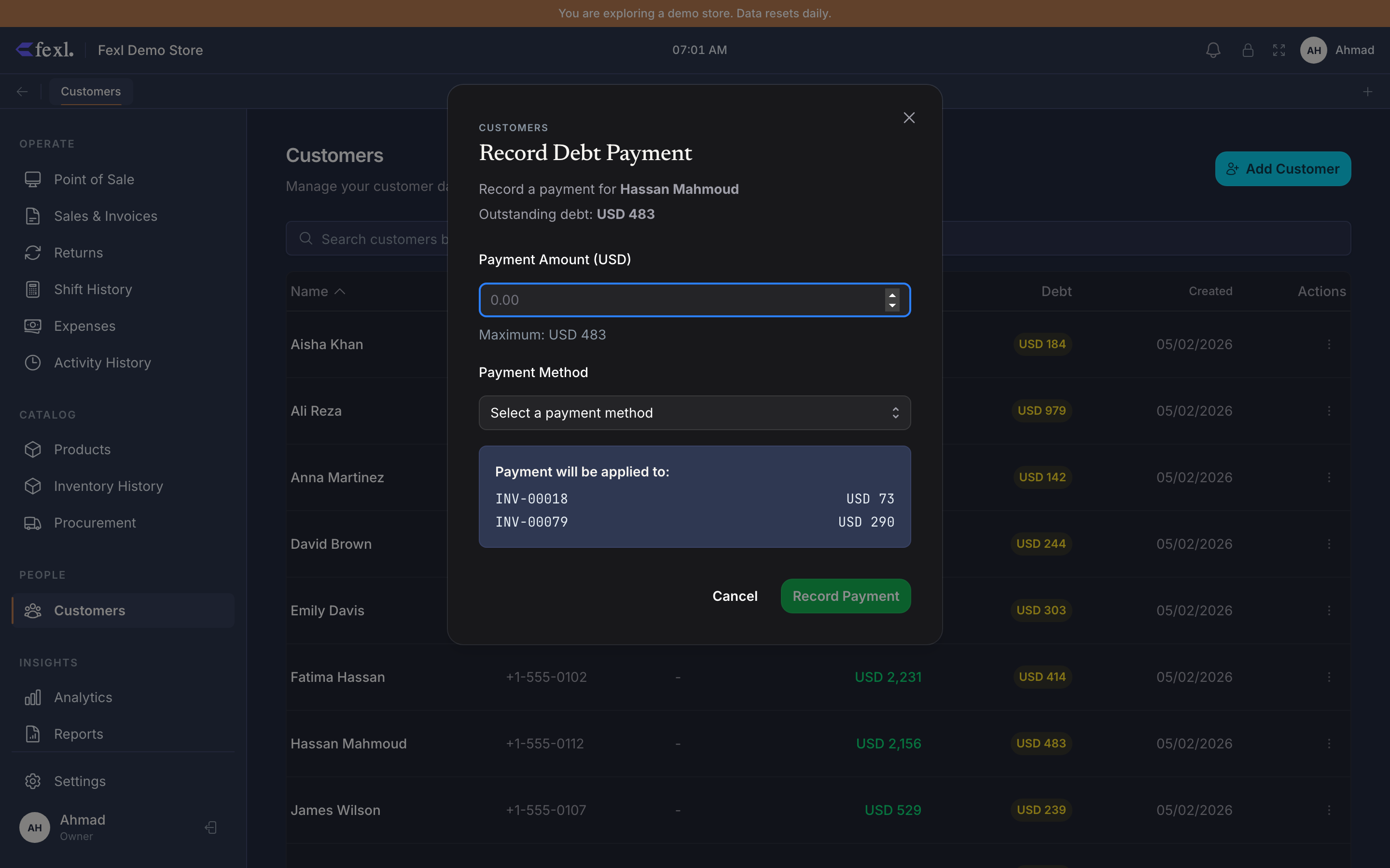 Record Debt Payment dialog for Hassan Mahmoud — outstanding debt USD 483 banner, Payment Amount (USD) input, Payment Method picker, Payment will be applied to: card listing INV-00018 USD 73 + INV-00079 USD 290 (oldest-first allocation), Cancel / Record Payment buttons